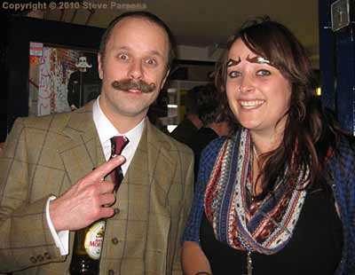 Taryn shows off her Mo-brows; Steve gets the point.