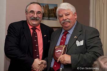 Rod Littlewood presents Michael Tierney with the Handlebar Club shield