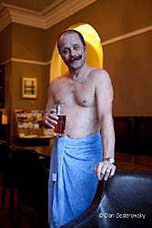 A picture of our secretary drinking a pint of bitter in a blue towel